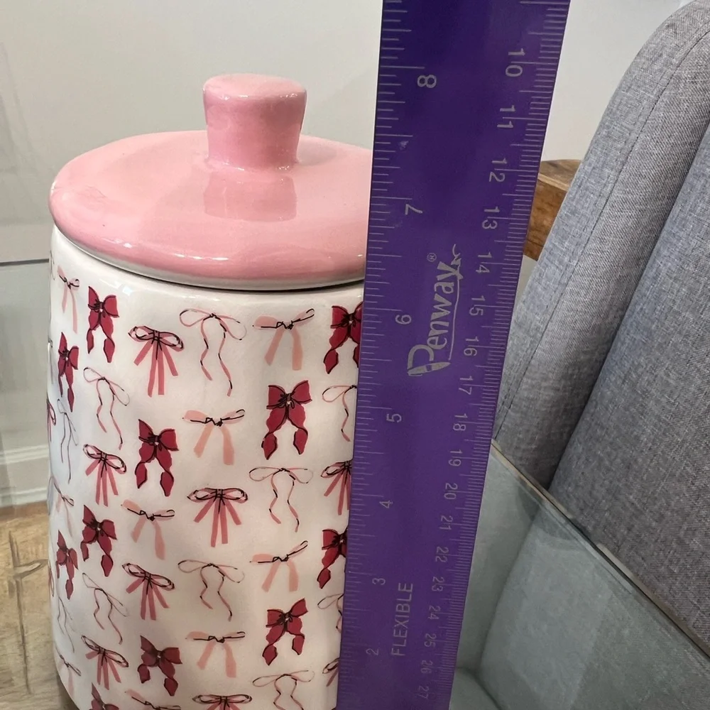 canister jar with a pink bow design, from the brand 10 Strawberry Stree